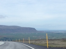 Driving down the mountain towards Hveragerði, blue skies all around.